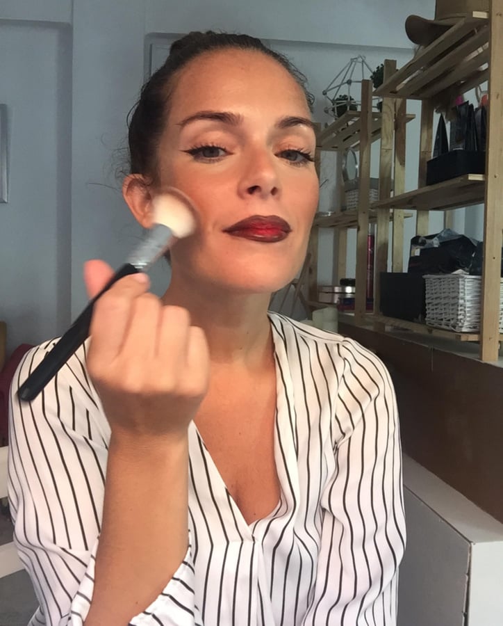 girl bloger with a makeup brush in hand